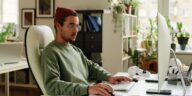 man working on a computer from home