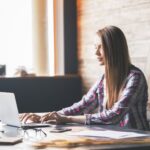 woman typing on a laptop