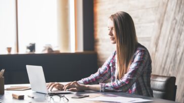 woman typing on a laptop