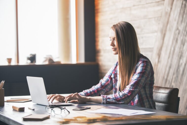 woman typing on a laptop