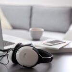 headphones next to a laptop on a table in a living room