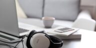 headphones next to a laptop on a table in a living room