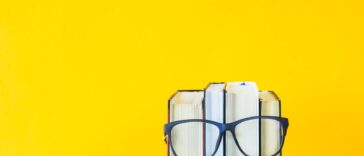 a stack of books with glasses